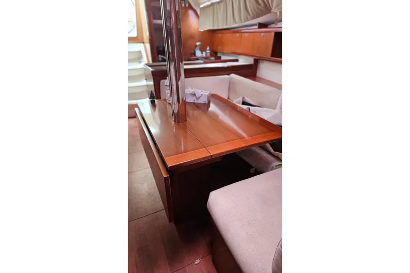 Slide: The Image of Interior of 2010 Beneteau Oceanis 34 GT yacht with wooden furnishings and cozy seating. - 27