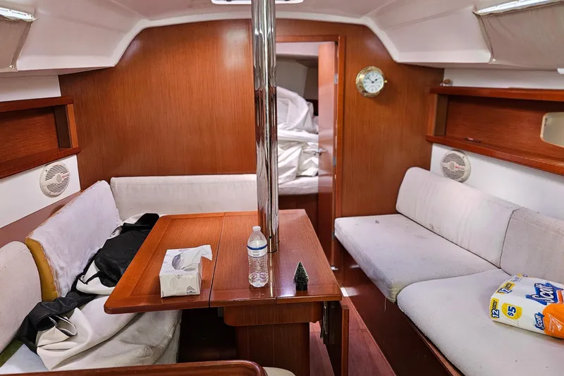 Slide: The Image of Interior of 2010 Beneteau Oceanis 34 GT yacht with cozy seating and wooden cabinetry. - 29
