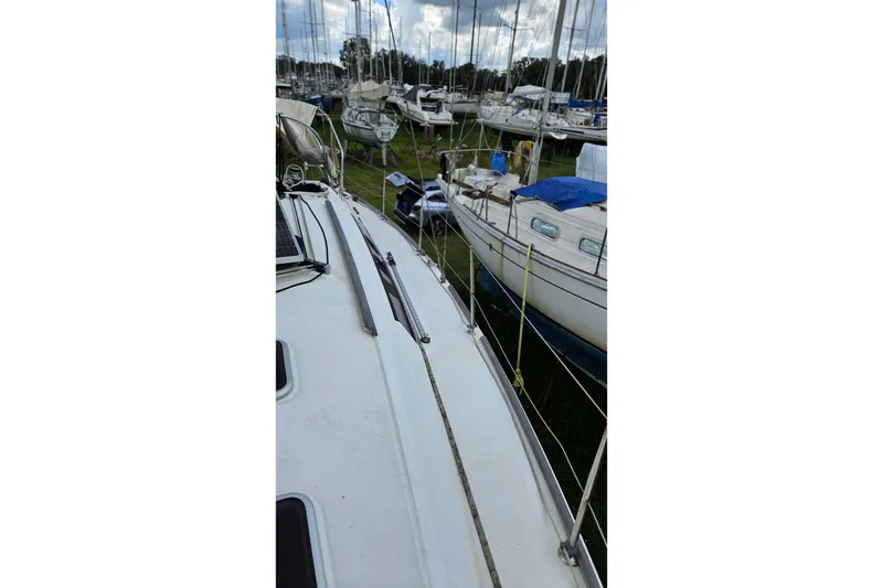 Slide: The Image of Beneteau Oceanis 34 GT 2010 sailboat deck with cleaning tools and fender. - 36