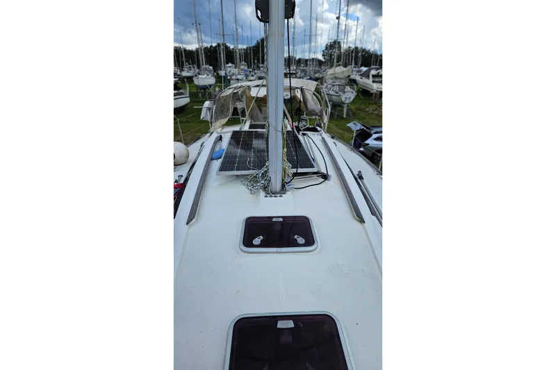 Slide: The Image of Beneteau Oceanis 34 GT 2010 sailboat docked among other boats in a marina. - 37