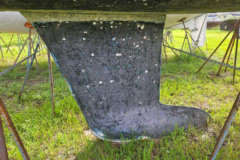 Slide: The Image of 2010 Beneteau Oceanis 34 GT sailboat on land under a blue sky. - 45