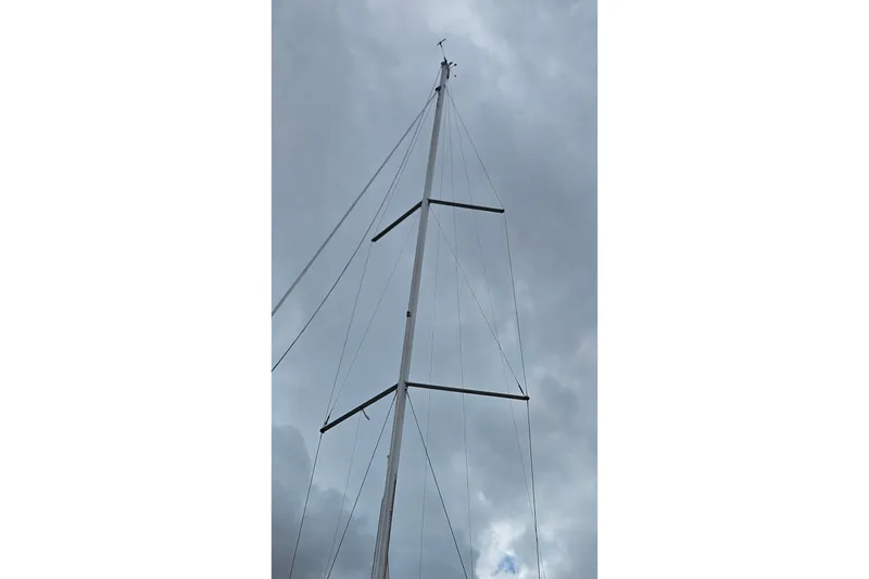 Slide: The Image of Beneteau Oceanis 34 GT 2010 sailboat on stands, grassy yard, blue sky background. - 6