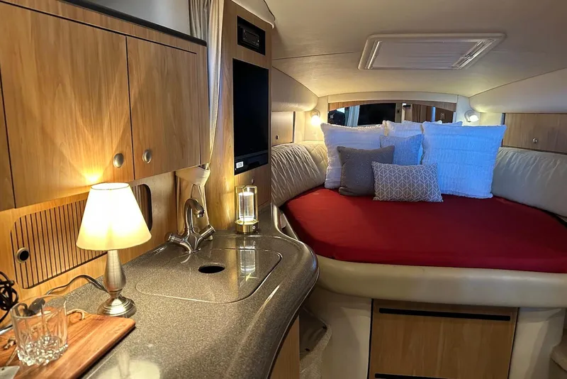 Slide: The Image of Interior of 2006 Sea Ray 320 Sundancer with cozy bed and elegant wooden cabinetry. - 25