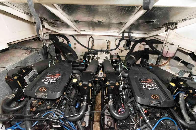 Slide: The Image of Engine room of a 2006 Sea Ray 320 Sundancer with twin engines and detailed components. - 32