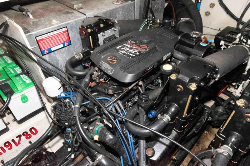 Slide: The Image of Engine compartment of a 2006 Sea Ray 320 Sundancer boat, showcasing mechanical components. - 33