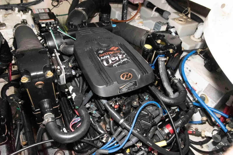 Slide: The Image of Engine compartment of a 2006 Sea Ray 320 Sundancer, showcasing detailed mechanical components. - 34