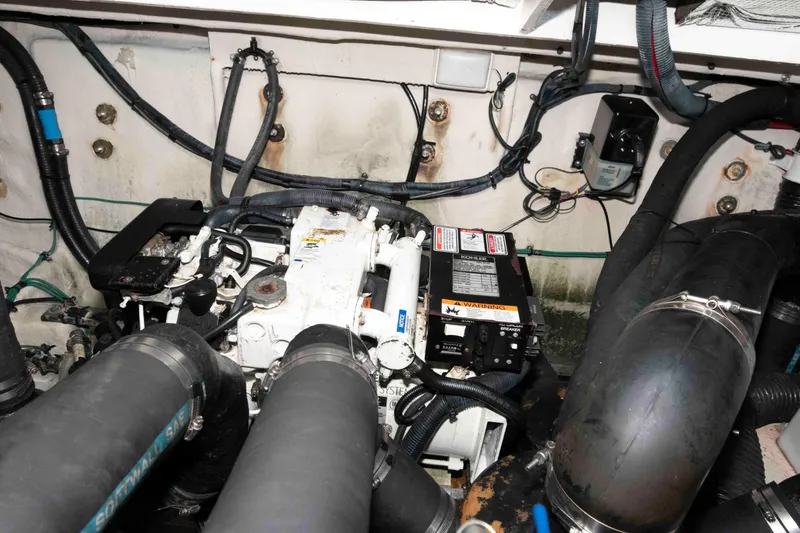 Slide: The Image of Engine compartment of a 2006 Sea Ray 320 Sundancer boat, showing mechanical components. - 35