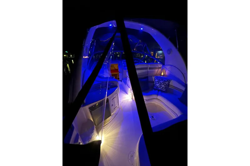 Slide: The Image of 2006 Sea Ray 320 Sundancer interior with blue ambient lighting at night. - 36