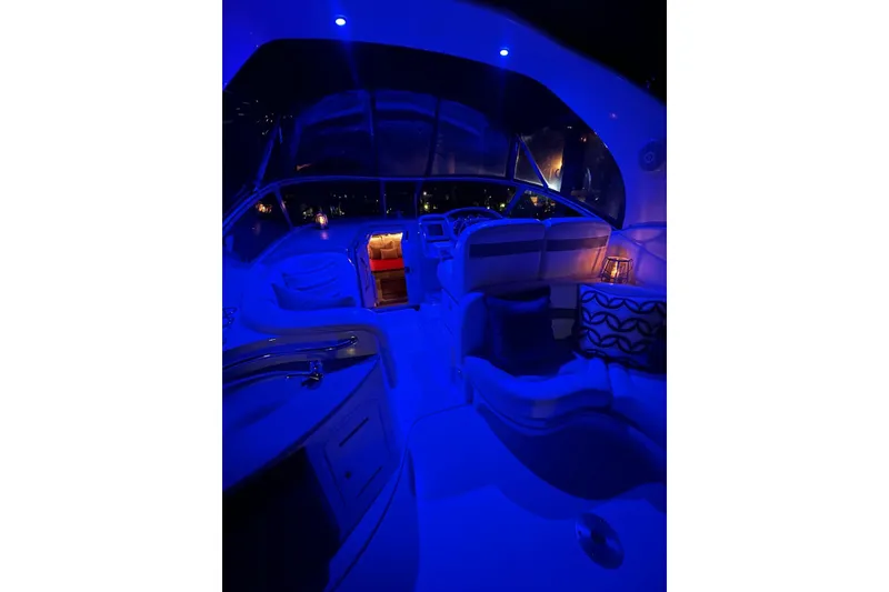 Slide: The Image of 2006 Sea Ray 320 Sundancer interior with blue ambient lighting at night. - 37