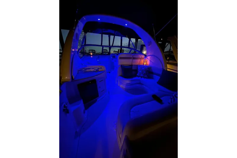 Slide: The Image of Interior of 2006 Sea Ray 320 Sundancer with blue ambient lighting at night. - 38