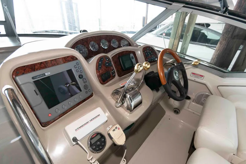 Slide: The Image of Interior view of 2006 Sea Ray 320 Sundancer boat cockpit with helm and seating. - 6