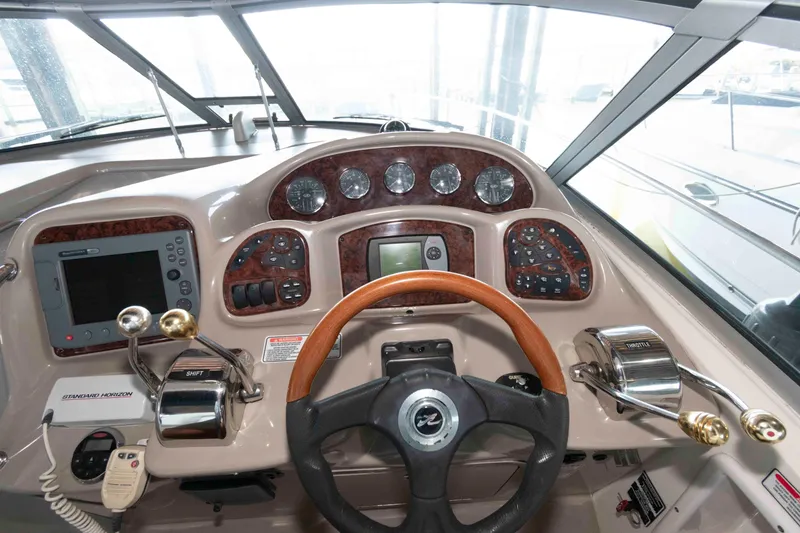 Slide: The Image of Interior cockpit of 2006 Sea Ray 320 Sundancer with white seating and control panel. - 7