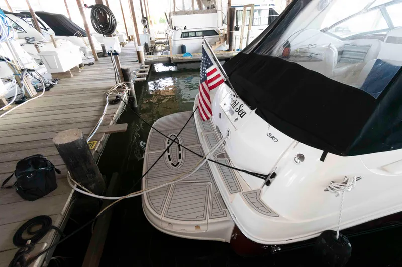 Slide: The Image of Cockpit of 2006 Sea Ray 320 Sundancer with steering wheel and navigation controls. - 9