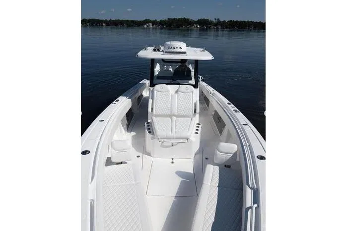 Slide: The Image of 2024 Fountain Bluewater 38 Tournament Edition boat on calm water, featuring sleek white design. - 11