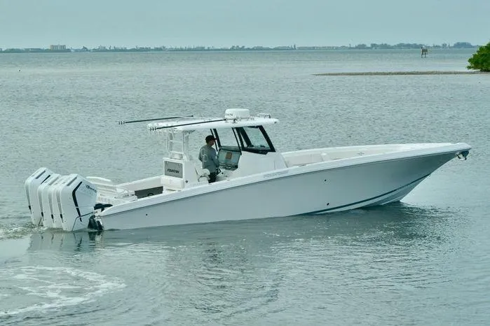 Slide: The Image of 2024 Fountain Bluewater 38 Tournament Edition boat cruising on calm waters. - 2