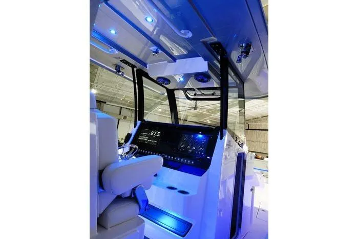 Slide: The Image of 2024 Fountain Bluewater 38 Tournament Edition boat interior with illuminated dashboard and seating. - 21