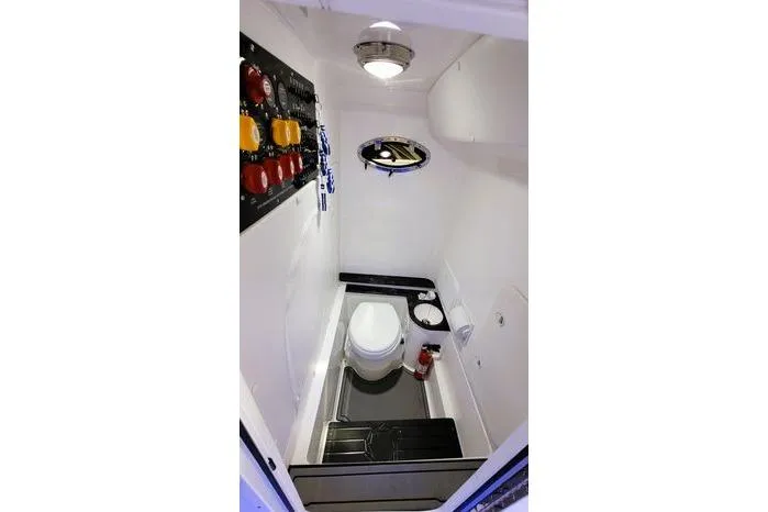 Slide: The Image of 2024 Fountain Bluewater 38 Tournament Edition boat bathroom interior with modern fixtures. - 25