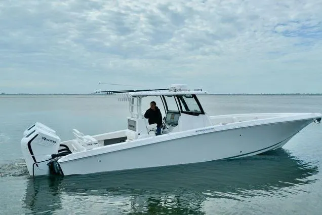 Slide: The Image of 2024 Fountain Bluewater 38 Tournament Edition boat on calm water under cloudy sky. - 3