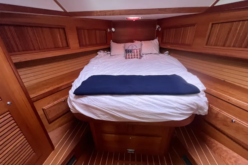 Slide: The Image of Cozy cabin interior of 2004 Sabre 36 Hardtop Sedan with wooden paneling and comfortable bedding. - 11