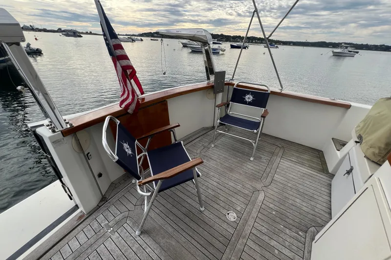 Slide: The Image of 2004 Sabre 36 Hardtop Sedan boat deck with chairs and American flag. - 13