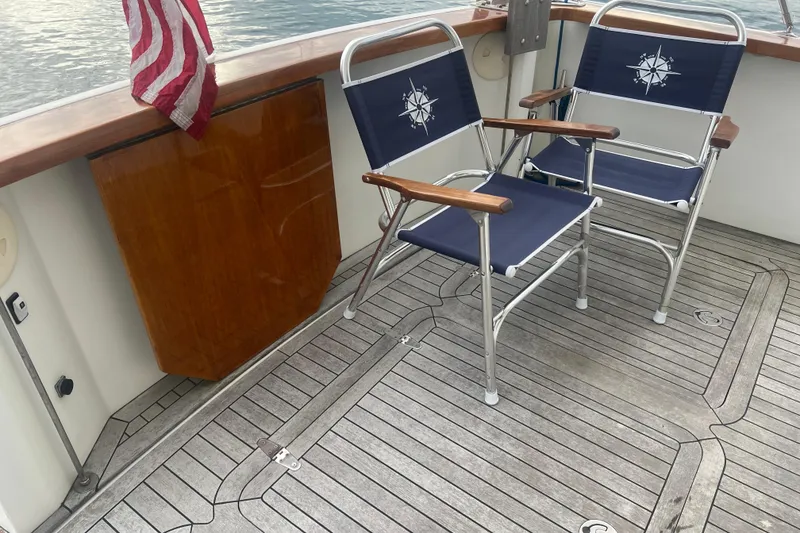 Slide: The Image of 2004 Sabre 36 Hardtop Sedan deck with chairs and American flag. - 14