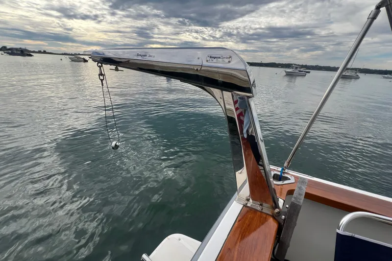 Slide: The Image of 2004 Sabre 36 Hardtop Sedan boat with davit arm over calm water. - 17