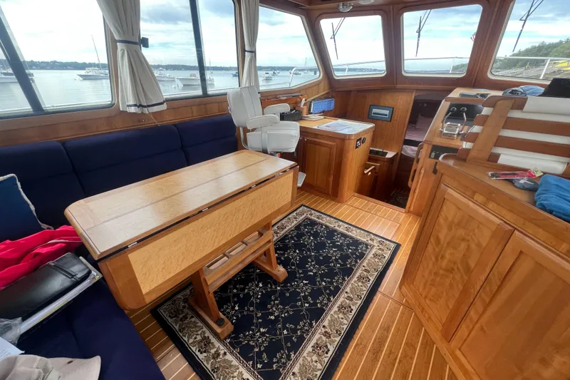 Slide: The Image of 2004 Sabre 36 Hardtop Sedan interior with wooden furnishings and nautical decor. - 2