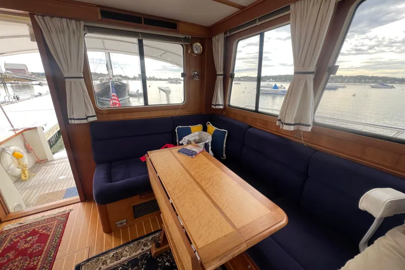 Slide: The Image of Interior of 2004 Sabre 36 Hardtop Sedan with blue seating and wooden table. - 3