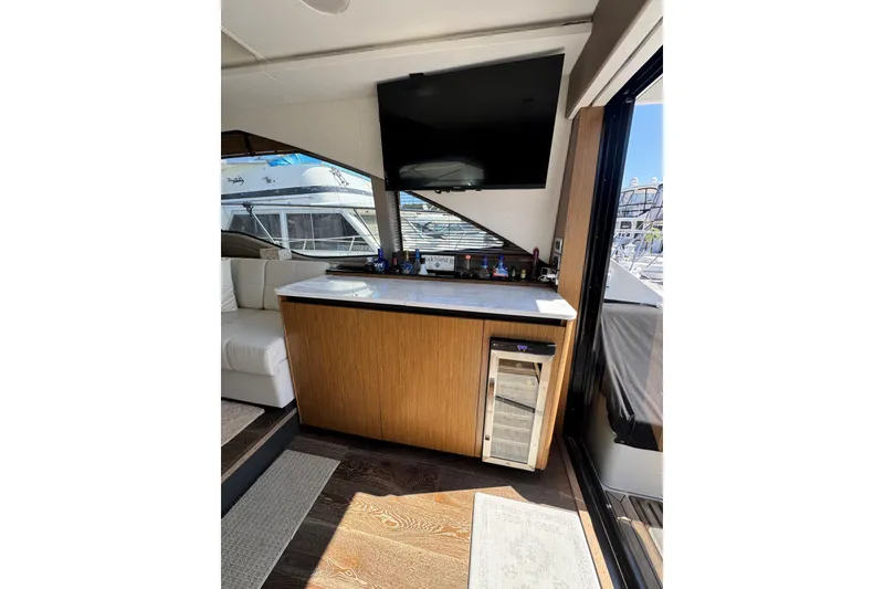 Slide: The Image of 2017 Sea Ray Sundancer 460 yacht deck with teak flooring and black seat covers. - 21