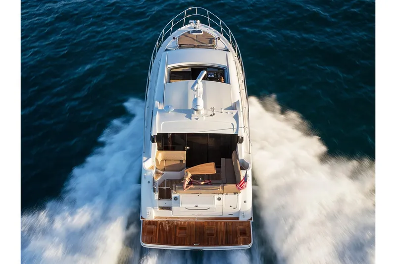 Slide: The Image of Wine cooler in 2017 Sea Ray Sundancer 460 yacht interior, featuring wooden cabinetry and modern design. - 4