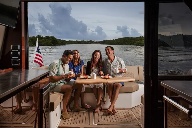 Slide: The Image of Luxurious interior of 2017 Sea Ray Sundancer 460 yacht with plush seating and marina view. - 7