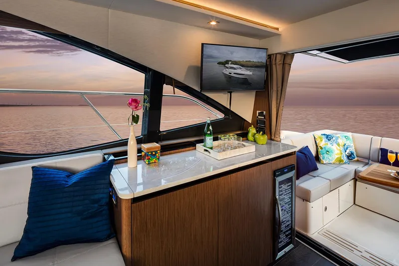 Slide: The Image of 2017 Sea Ray Sundancer 460 helm with modern controls and comfortable seating. - 9