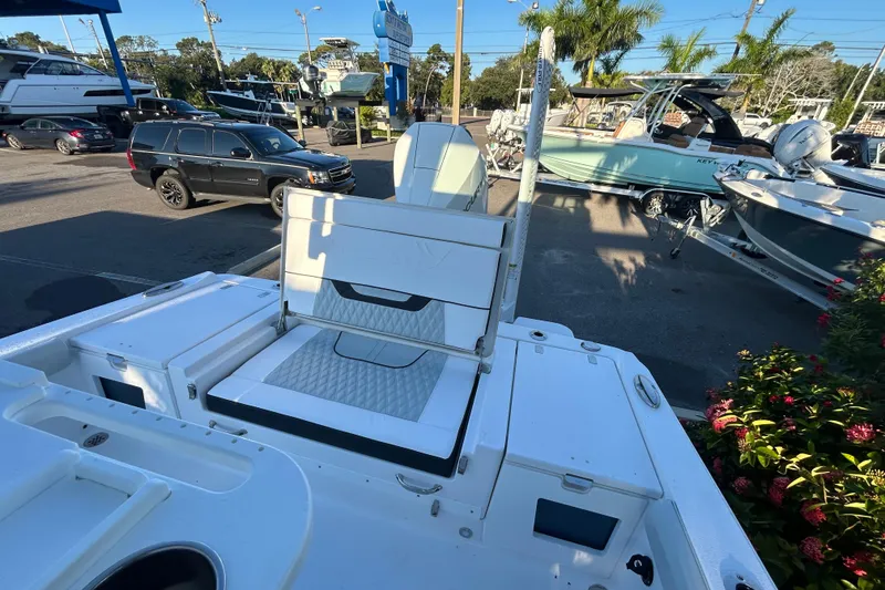 Slide: The Image of 2026 Blackfin 242 HB boat interior with seating, parked in a marina. - 10