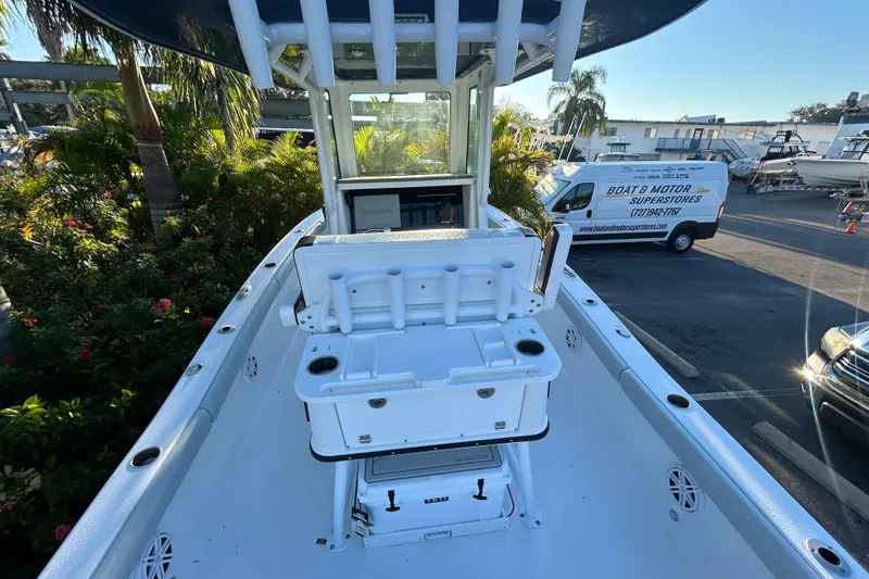 Slide: The Image of 2026 Blackfin 242 HB boat interior with fishing rod holders and Garmin equipment. - 11
