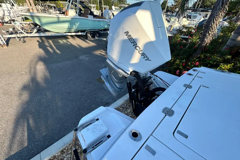 Slide: The Image of 2026 Blackfin 242 HB boat with Mercury outboard engine in a marina setting. - 14