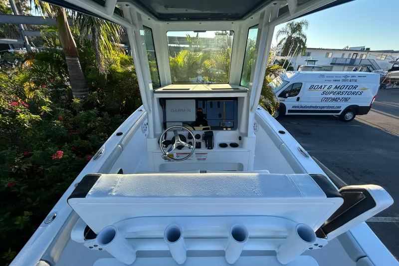 Slide: The Image of 2026 Blackfin 242 HB boat interior with Garmin navigation, docked near a motor store. - 4