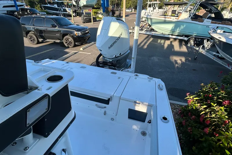 Slide: The Image of 2026 Blackfin 242 HB boat with Mercury engine in a parking lot. - 9
