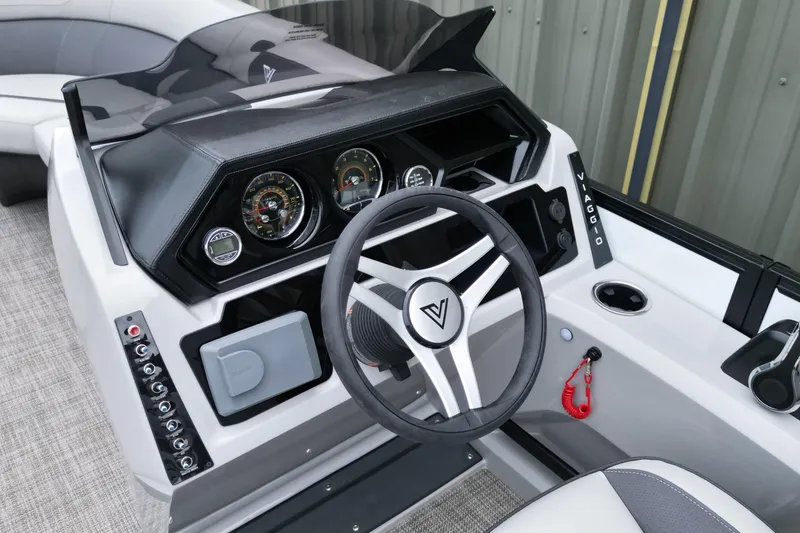 Slide: The Image of 2026 Viaggio Lago X-S boat dashboard with steering wheel and control panel. - 15