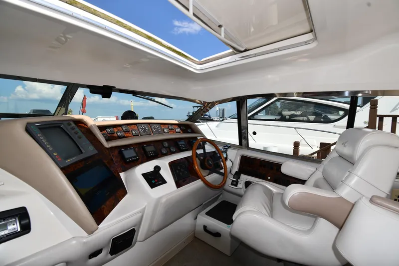 Slide: The Image of 1995 Sea Ray 630 Sundancer helm with luxurious seating and advanced navigation controls. - 11