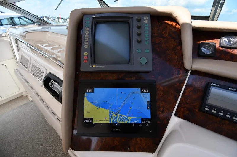 Slide: The Image of Control panel of a 1995 Sea Ray 630 Sundancer with navigation screens. - 13