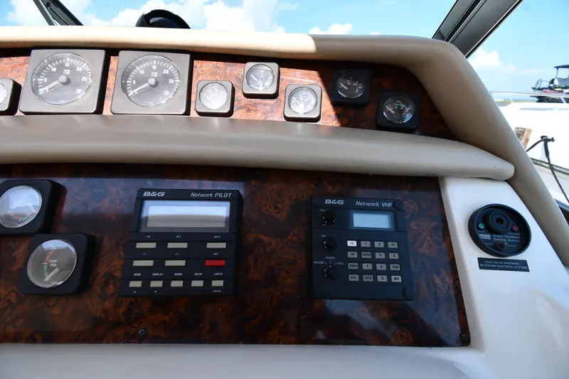 Slide: The Image of 1995 Sea Ray 630 Sundancer dashboard with gauges and navigation controls. - 14