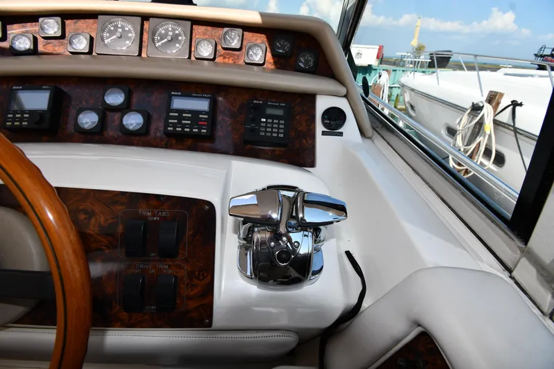 Slide: The Image of 1995 Sea Ray 630 Sundancer helm with gauges, controls, and wood accents. - 16