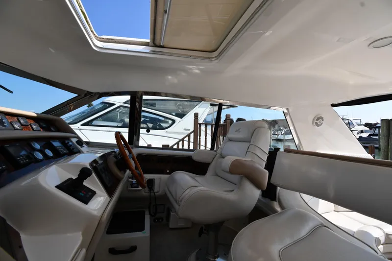 Slide: The Image of Interior of 1995 Sea Ray 630 Sundancer yacht with luxurious seating and control panel. - 19