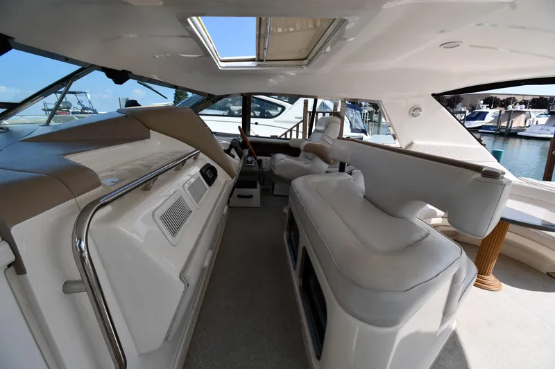 Slide: The Image of Interior view of 1995 Sea Ray 630 Sundancer yacht with plush seating and helm. - 21