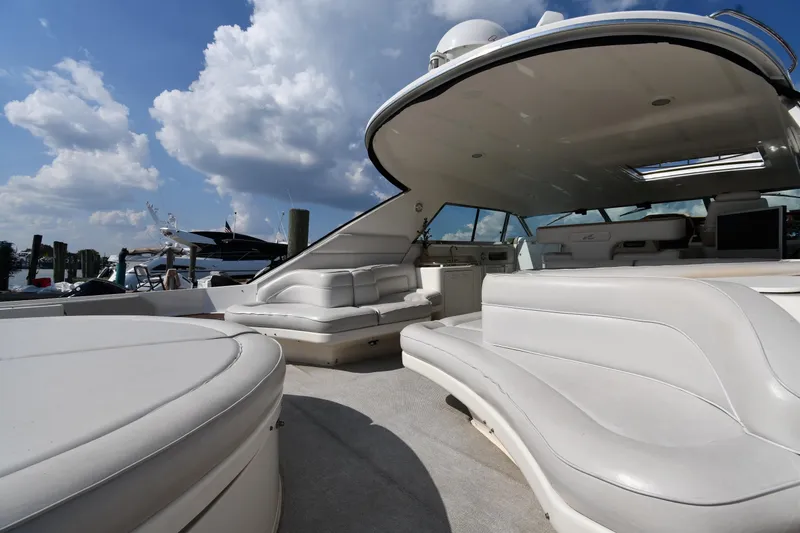 Slide: The Image of Luxurious 1995 Sea Ray 630 Sundancer yacht with spacious white seating under a blue sky. - 23