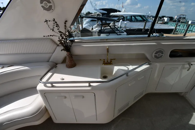 Slide: The Image of Luxurious interior of 1995 Sea Ray 630 Sundancer yacht with elegant seating and sink area. - 26