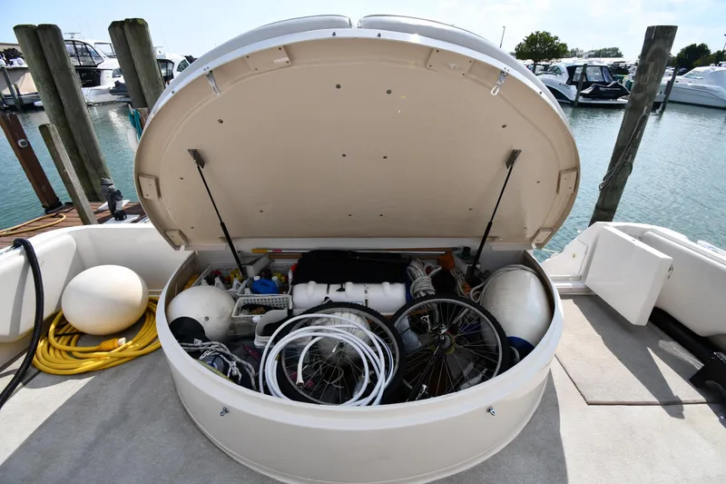 Slide: The Image of 1995 Sea Ray 630 Sundancer storage compartment filled with boating equipment and accessories. - 34