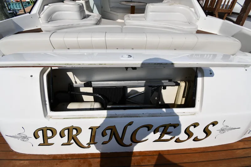 Slide: The Image of 1995 Sea Ray 630 Sundancer yacht with open storage compartment, labeled "PRINCESS." - 36