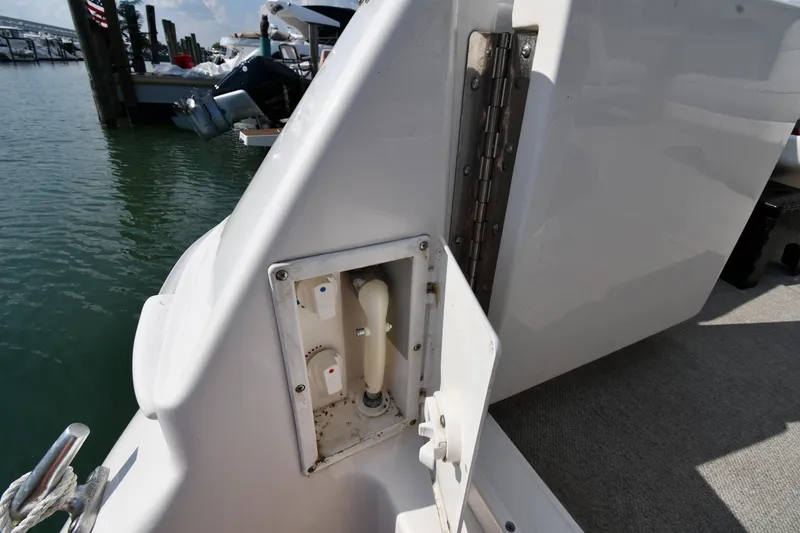 Slide: The Image of 1995 Sea Ray 630 Sundancer boat deck with utility panel, docked at marina. - 37