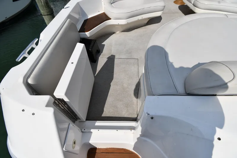 Slide: The Image of 1995 Sea Ray 630 Sundancer boat deck with white seating and carpeted floor. - 38